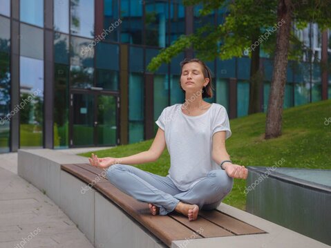 Woman practicing deep breathing at home.