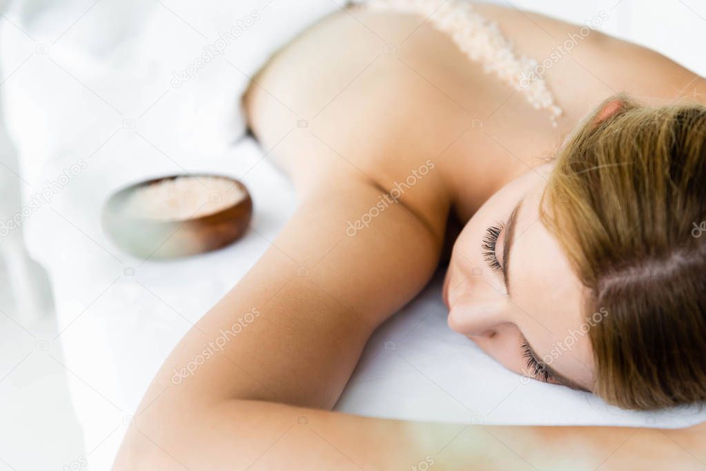 Client receiving a body scrub treatment.