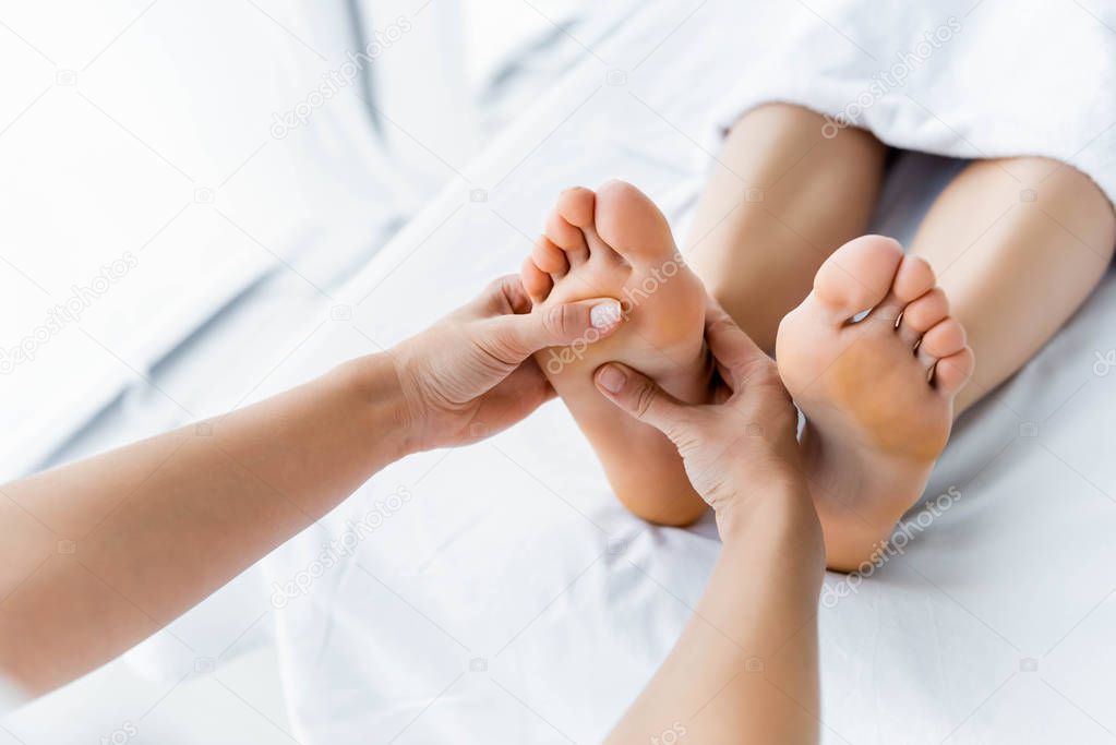 Reflexology session close-up.