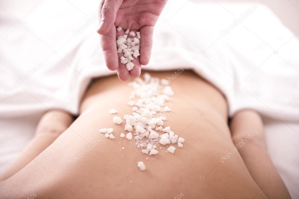 Sea salt and oil prepared for a body scrub.