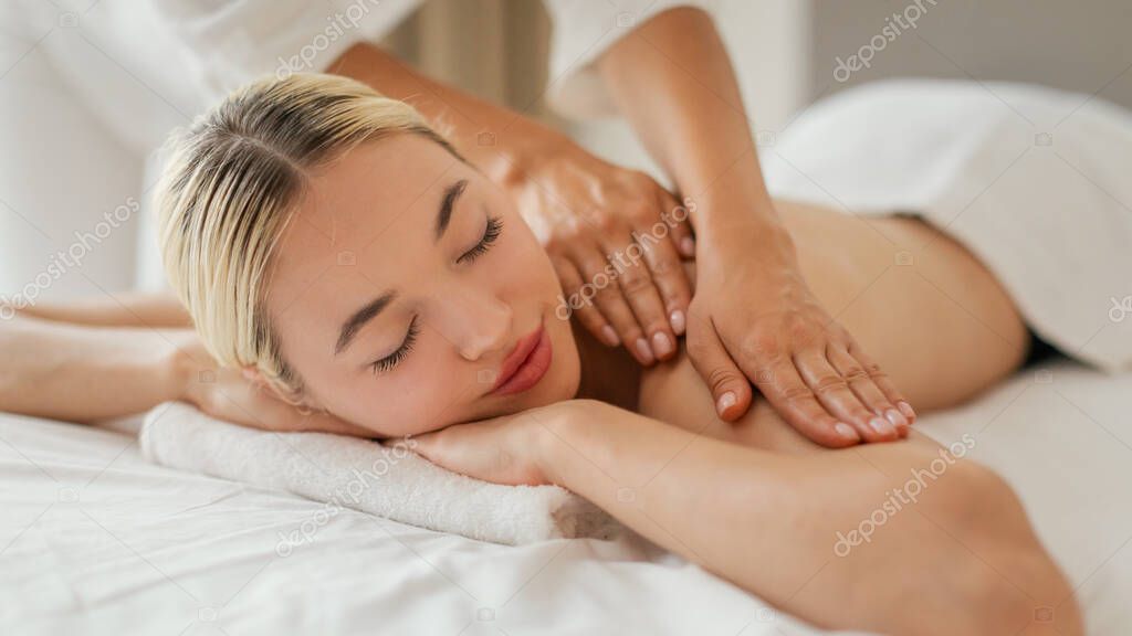 Therapist applying deep tissue massage.