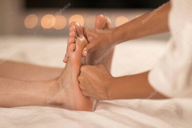 Therapist pressing reflex points on foot.