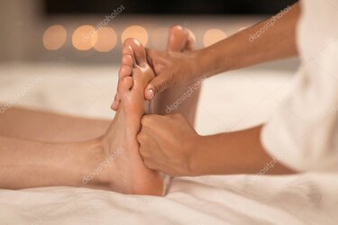 Therapist pressing reflex points on foot.