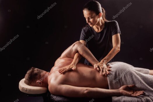 Close-up of therapist using elbow technique on back.